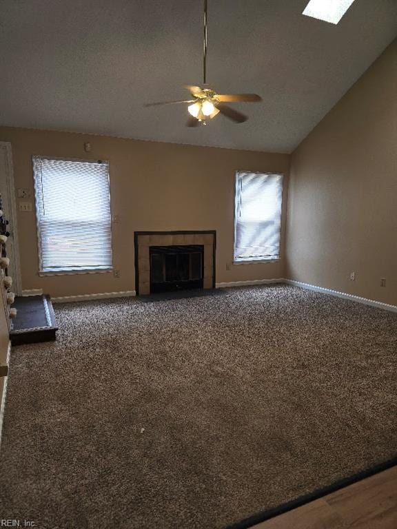 238 Susan Constant Dr, Newport News, VA 23608 - unfurnished living room featuring a tile fireplace, a ceiling fan, lofted ceiling, and carpet floors