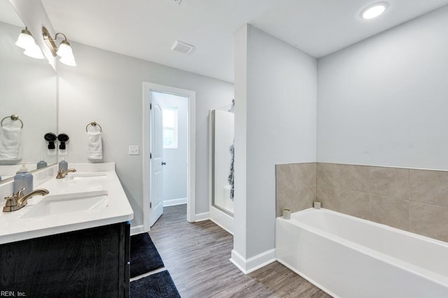 1332 Fishermans Rd, Norfolk, VA 23503 - bathroom featuring a garden tub, wood finished floors, double vanity, and a shower stall