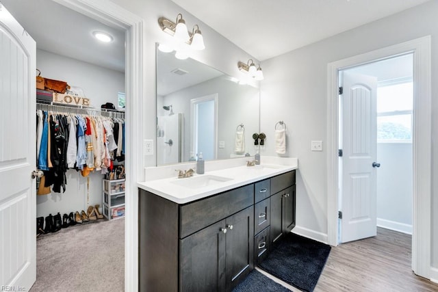 1332 Fishermans Rd, Norfolk, VA 23503 - full bath with double vanity, a walk in closet, and wood finished floors