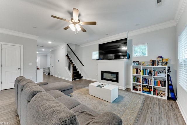 1332 Fishermans Rd, Norfolk, VA 23503 - living room featuring stairway, wood finished floors, ceiling fan, crown molding, and a glass covered fireplace