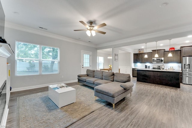 1332 Fishermans Rd, Norfolk, VA 23503 - living area with wood finished floors, ceiling fan, and crown molding
