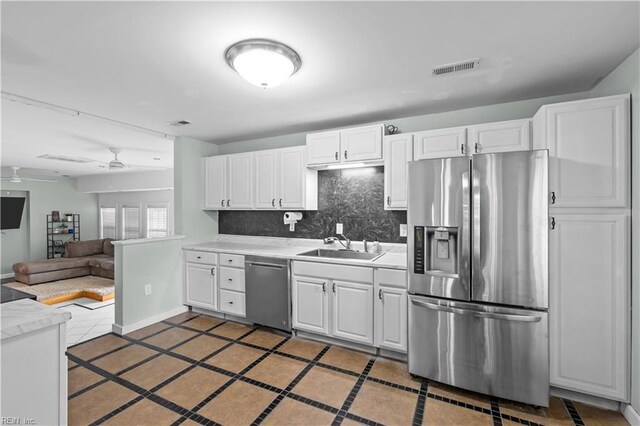 2320 Early St, Norfolk, VA 23513 - kitchen with stainless steel appliances, a ceiling fan, light tile patterned floors, light countertops, and decorative backsplash