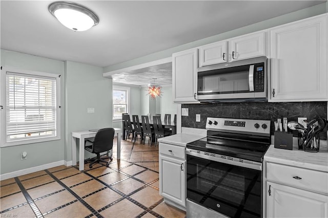 2320 Early St, Norfolk, VA 23513 - kitchen featuring stainless steel appliances, decorative backsplash, light countertops, and inlaid floor details