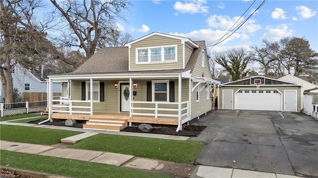 2320 Early St, Norfolk, VA 23513 - view of front of home with a garage, an outdoor structure, a porch, and a shingled roof