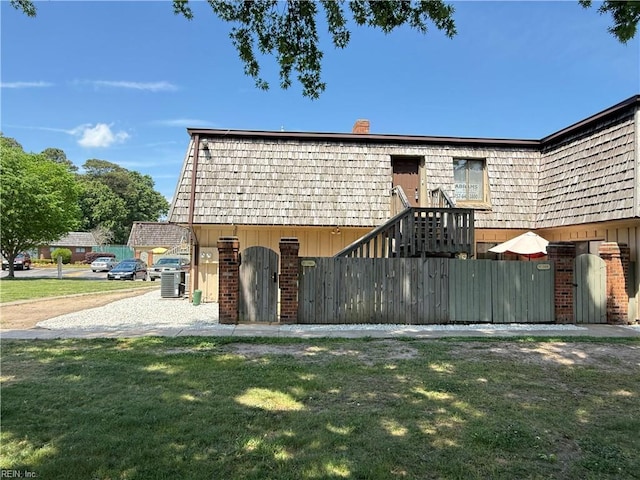 146 Saw Grass Bnd, Virginia Beach, VA 23451 - view of front facade with mansard roof, brick siding, and a chimney