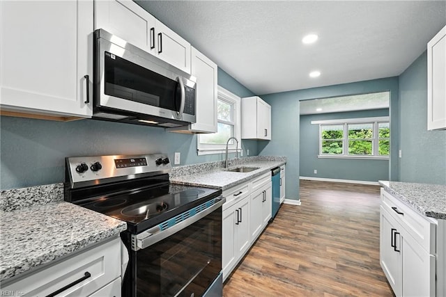 2214 Berkley Ave, Chesapeake, VA 23324 - kitchen featuring appliances with stainless steel finishes, dark wood-style floors, white cabinetry, and recessed lighting