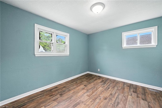 2214 Berkley Ave, Chesapeake, VA 23324 - empty room with wood finished floors, a textured ceiling, and a textured wall