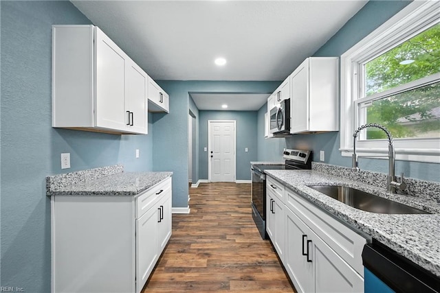 2214 Berkley Ave, Chesapeake, VA 23324 - kitchen with stainless steel appliances, dark wood finished floors, light stone counters, white cabinets, and recessed lighting
