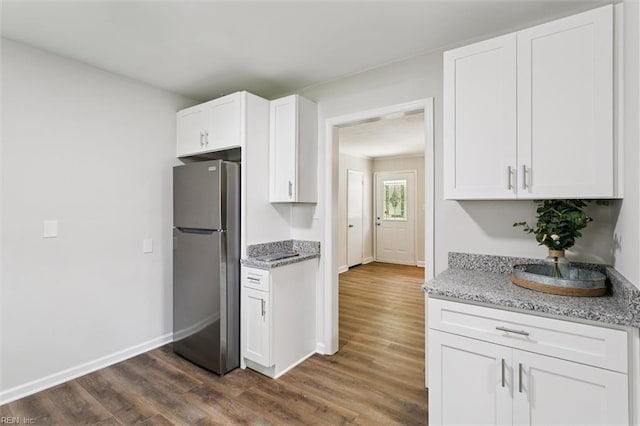 433 Queens Creek Rd, Williamsburg, VA 23185 - kitchen with freestanding refrigerator, dark wood-style floors, light stone counters, and white cabinetry