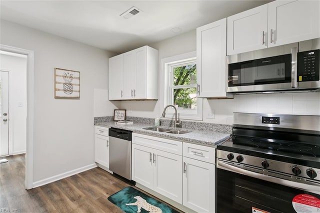 433 Queens Creek Rd, Williamsburg, VA 23185 - kitchen with stainless steel appliances, dark wood-style floors, white cabinetry, light stone counters, and backsplash