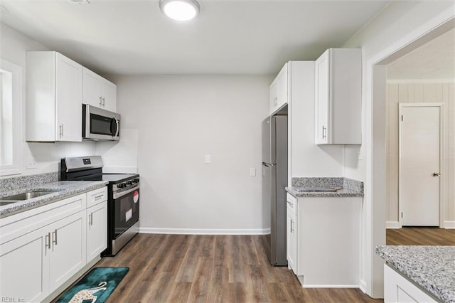 433 Queens Creek Rd, Williamsburg, VA 23185 - kitchen featuring stainless steel appliances, white cabinetry, and light stone counters