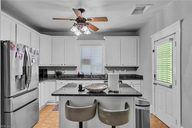 118 Saint James Ave, Suffolk, VA 23434 - kitchen featuring stainless steel refrigerator with ice dispenser, white cabinetry, light tile patterned floors, a ceiling fan, and a kitchen island