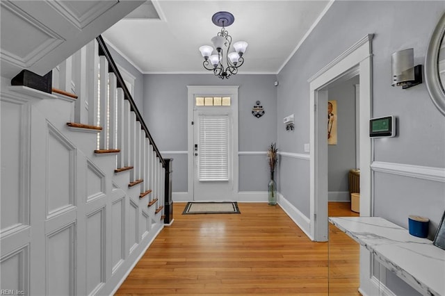 118 Saint James Ave, Suffolk, VA 23434 - entrance foyer with light wood-style flooring, crown molding, a chandelier, and stairway