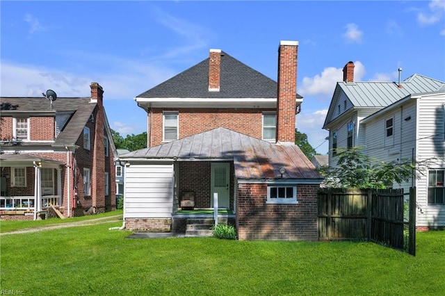 118 Saint James Ave, Suffolk, VA 23434 - rear view of property with a standing seam roof, brick siding, a chimney, and a metal roof
