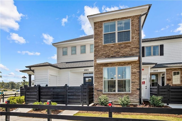 1003 Kathy Ann Way E, Carrollton, VA 23314 - view of front of home featuring stone siding and a gate