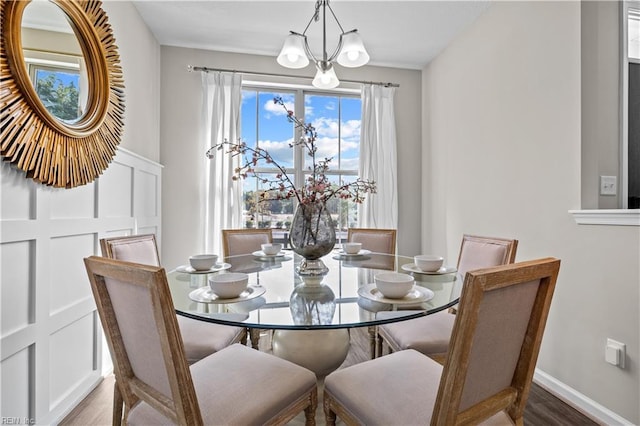 1003 Kathy Ann Way E, Carrollton, VA 23314 - dining room with a chandelier, wood finished floors, and a wainscoted wall