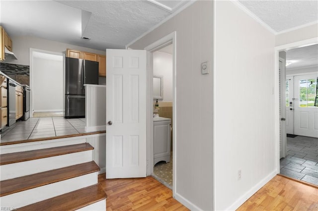 127 Robinson Dr, Newport News, VA 23601 - stairs with wood finished floors, a textured ceiling, and ornamental molding