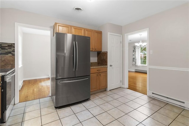 127 Robinson Dr, Newport News, VA 23601 - kitchen with stainless steel appliances, baseboard heating, light tile patterned flooring, and a chandelier