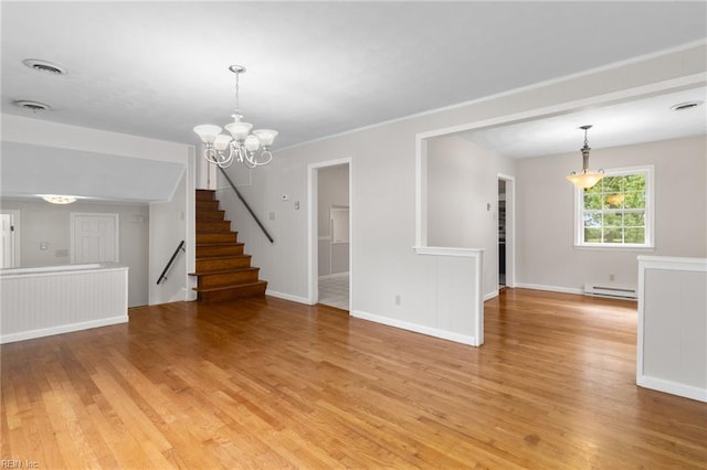 127 Robinson Dr, Newport News, VA 23601 - unfurnished living room with a baseboard radiator, light wood finished floors, a chandelier, and stairway