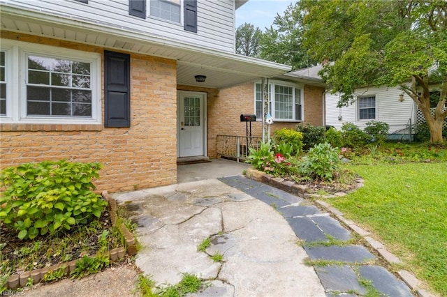 127 Robinson Dr, Newport News, VA 23601 - view of exterior entry with a yard and brick siding