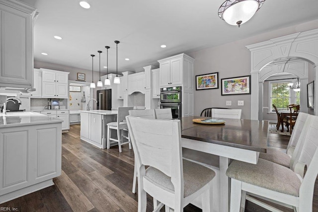 205 Napoli Ct, Chesapeake, VA 23322 - dining area with arched walkways, recessed lighting, and dark wood finished floors