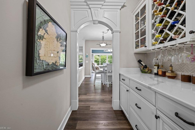 205 Napoli Ct, Chesapeake, VA 23322 - indoor dry bar featuring decorative backsplash, arched walkways, and dark wood-type flooring