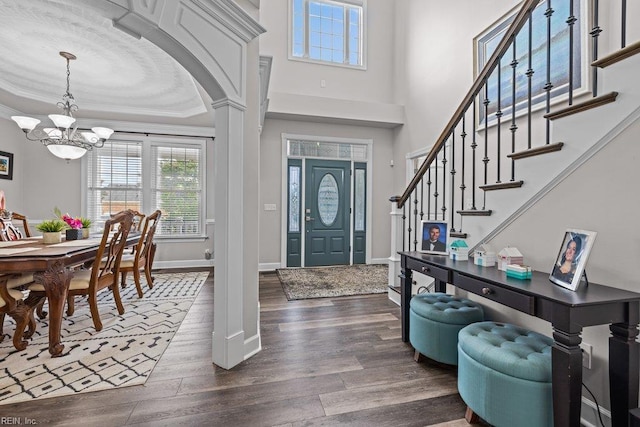 205 Napoli Ct, Chesapeake, VA 23322 - entryway featuring a chandelier, dark wood-type flooring, stairs, crown molding, and a towering ceiling