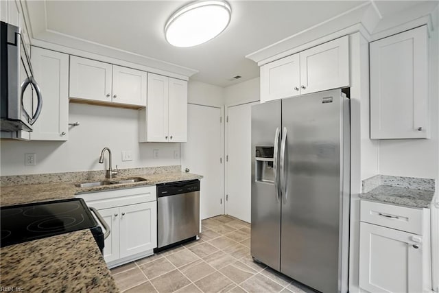 1207 Hazel Ave, Chesapeake, VA 23325 - kitchen featuring appliances with stainless steel finishes, white cabinetry, light stone countertops, and light tile patterned floors