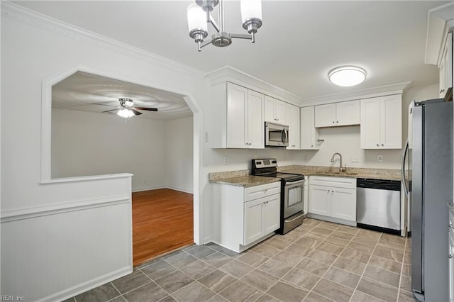 1207 Hazel Ave, Chesapeake, VA 23325 - kitchen with stainless steel appliances, white cabinets, light stone counters, a ceiling fan, and crown molding