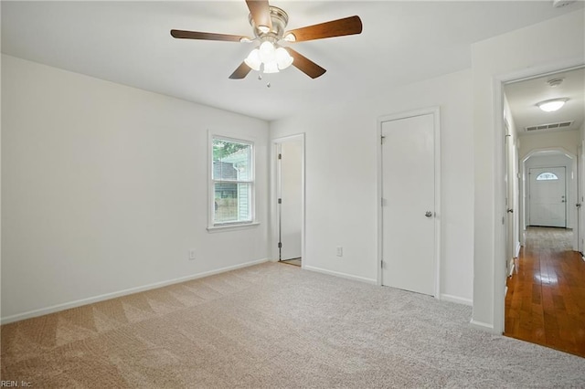 1207 Hazel Ave, Chesapeake, VA 23325 - unfurnished bedroom with carpet, arched walkways, and a ceiling fan