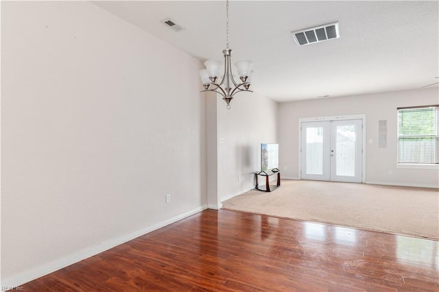 222 Craftsman Cir, Suffolk, VA 23434 - unfurnished room featuring a chandelier, french doors, and wood finished floors