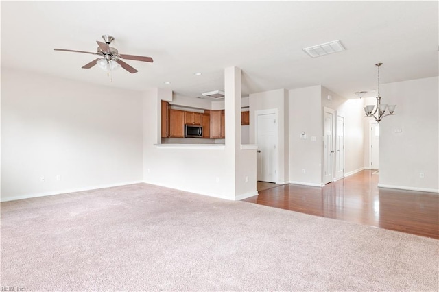 222 Craftsman Cir, Suffolk, VA 23434 - unfurnished living room featuring carpet flooring, ceiling fan, and a chandelier