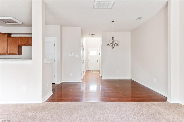 222 Craftsman Cir, Suffolk, VA 23434 - unfurnished living room with carpet, a chandelier, and wood finished floors