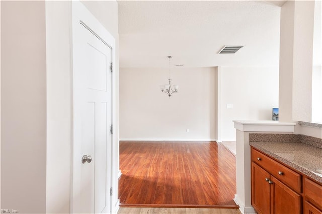 222 Craftsman Cir, Suffolk, VA 23434 - hall with light wood-type flooring and a chandelier