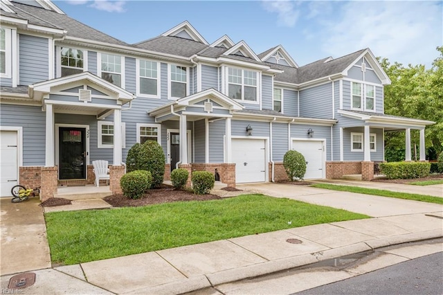 222 Craftsman Cir, Suffolk, VA 23434 - view of property with brick siding, concrete driveway, a garage, and a front lawn