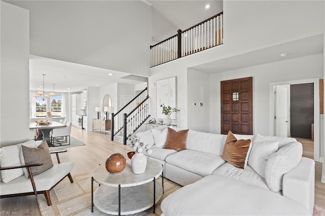 2013 Munro Ln, Chesapeake, VA 23322 - living room with light wood-style floors, stairs, and a towering ceiling