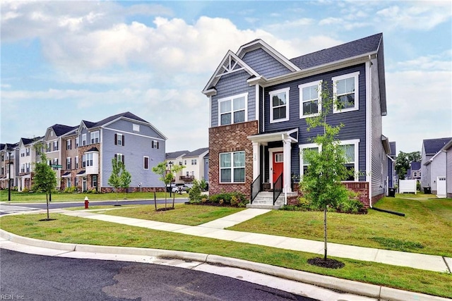 134 Fishermans Way, Poquoson, VA 23662 - view of front facade with a residential view, brick siding, and a front lawn