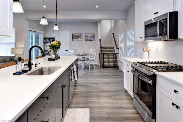 134 Fishermans Way, Poquoson, VA 23662 - kitchen featuring stainless steel appliances, light countertops, recessed lighting, light wood finished floors, and decorative backsplash