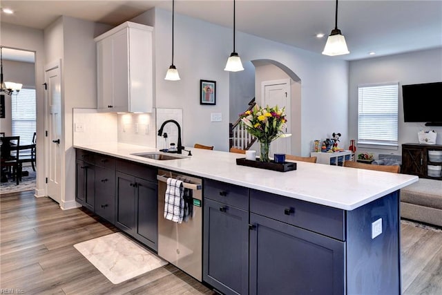 134 Fishermans Way, Poquoson, VA 23662 - kitchen with stainless steel dishwasher, open floor plan, a peninsula, arched walkways, and light wood-style flooring