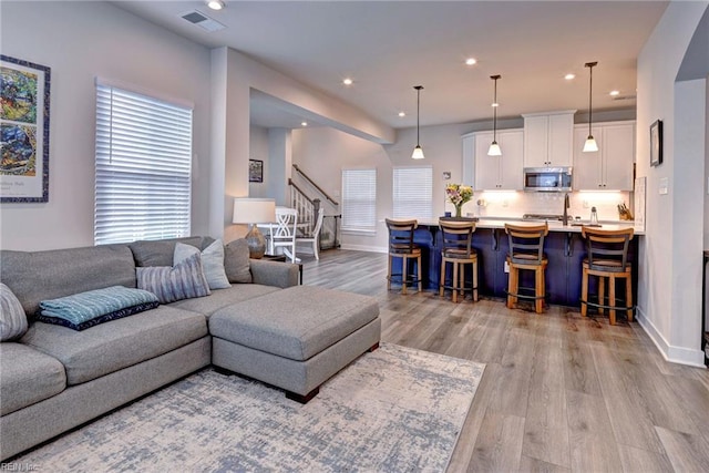 134 Fishermans Way, Poquoson, VA 23662 - living room with stairs, wood finished floors, and recessed lighting