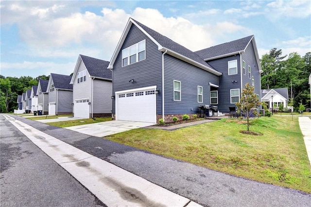 134 Fishermans Way, Poquoson, VA 23662 - view of side of property featuring an attached garage, driveway, and a yard