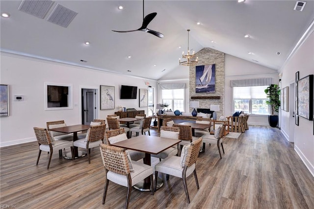 134 Fishermans Way, Poquoson, VA 23662 - dining space featuring wood finished floors, a stone fireplace, recessed lighting, a ceiling fan, and high vaulted ceiling