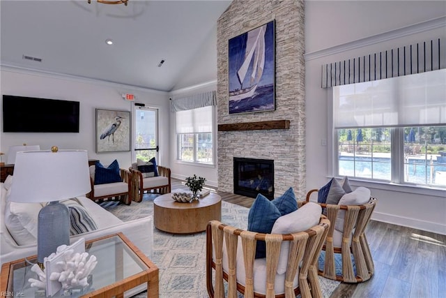 134 Fishermans Way, Poquoson, VA 23662 - living area with plenty of natural light, wood finished floors, high vaulted ceiling, and a stone fireplace