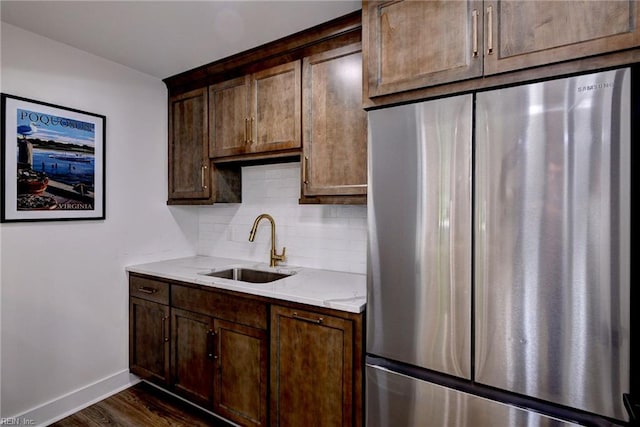 134 Fishermans Way, Poquoson, VA 23662 - kitchen featuring freestanding refrigerator, backsplash, dark wood finished floors, light stone countertops, and dark brown cabinetry