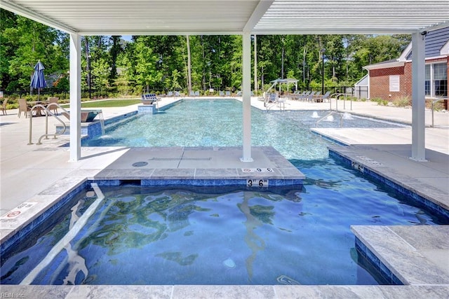 134 Fishermans Way, Poquoson, VA 23662 - community pool with a hot tub, a patio area, and view of wooded area