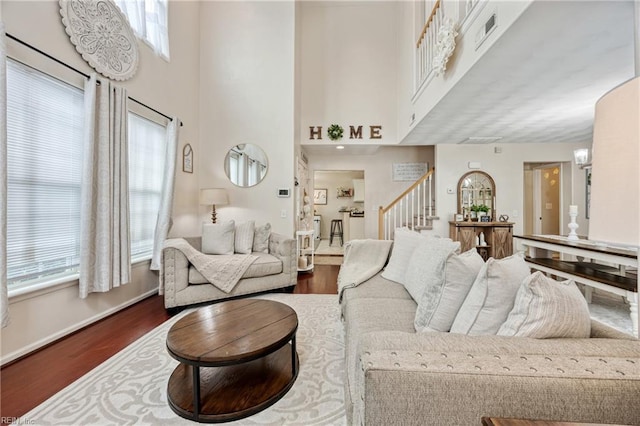 6729 Hampton Roads Pkwy Unit D, Suffolk, VA 23435 - living area with stairway, dark wood-style floors, a high ceiling, and plenty of natural light