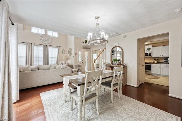 6729 Hampton Roads Pkwy Unit D, Suffolk, VA 23435 - dining area with dark wood finished floors, a chandelier, and stairway