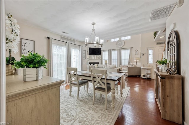 6729 Hampton Roads Pkwy Unit D, Suffolk, VA 23435 - dining room with a chandelier, plenty of natural light, dark wood-style flooring, and a fireplace