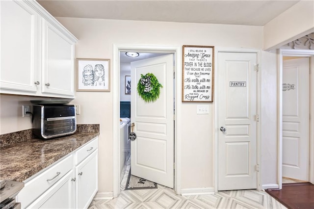 6729 Hampton Roads Pkwy Unit D, Suffolk, VA 23435 - kitchen with white cabinets and dark stone counters