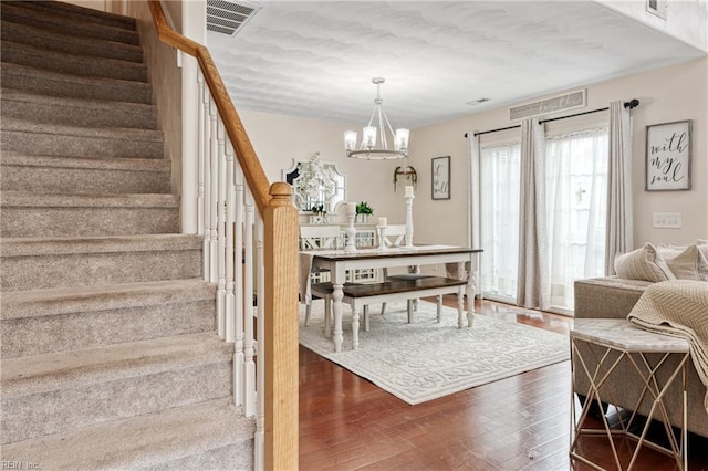 6729 Hampton Roads Pkwy Unit D, Suffolk, VA 23435 - living room with stairs, wood finished floors, and a chandelier